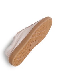 Light pink leather sneaker with a textured, rubber gum sole. Features a rounded toe and side stitching detail. Minimalist design.