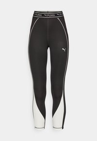 Leggings sportivi neri con pannelli laterali bianchi, tessuto testurizzato e vita con logo Puma bianco.