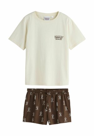 Crèmekleurig T-shirt met korte mouwen en Looney Tunes-logo en een korte bruine broek met kleine witte Tweety Bird tekeningen.