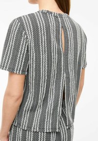 Gray and white striped top with short sleeves, textured fabric, and a back opening, featuring a simple and modern design.