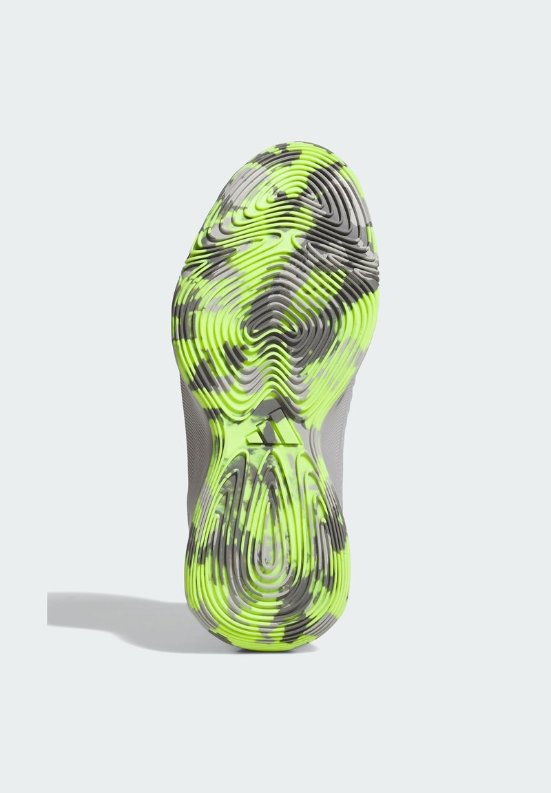 Semelle de chaussure avec des motifs ondulés intriqués en vert fluo et gris, dotée d'une surface texturée pour une meilleure adhérence et stabilité.