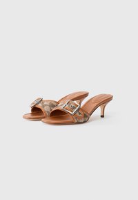 Brown heeled mules with a textured snake print pattern and a silver rectangular buckle detail, featuring a smooth leather sole and open design.