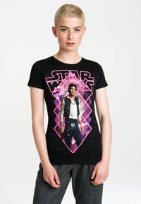 Black t-shirt featuring a stylized graphic of Han Solo from Star Wars, highlighted with pink and purple accents against a starry background.