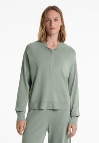 Ljusgrön zip-up hoodie i ribbat tyg, med huva, långa ärmar och en avslappnad passform med bandad nederkant.