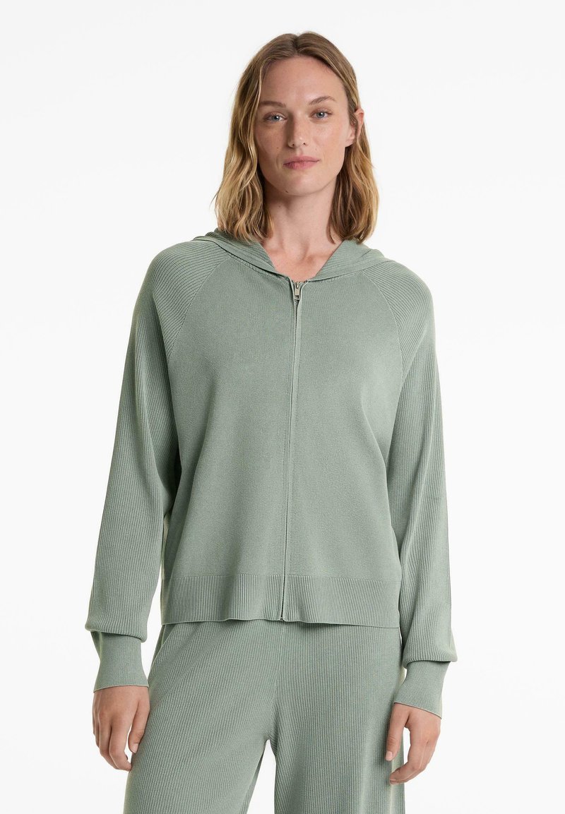 Ljusgrön zip-up hoodie i ribbat tyg, med huva, långa ärmar och en avslappnad passform med bandad nederkant.