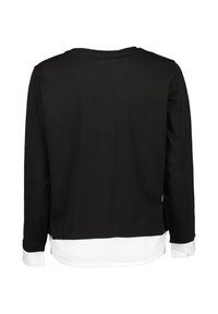Schwarzes Langarmshirt mit rundem Ausschnitt und einem kontrastierenden weißen Saum. Hat einen lockeren Schnitt und mit Knöpfen versehenen weißen Manschetten.
