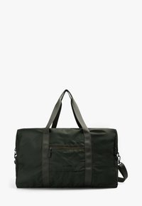 Bolsa de lona de color verde oscuro hecha de nylon, con dos asas para llevar, un bolsillo frontal con cremallera y una correa de hombro ajustable.