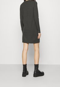 Knit sweater dress in dark grey, featuring long sleeves, ribbed cuffs, and hem, with a relaxed fit that falls above the knees.