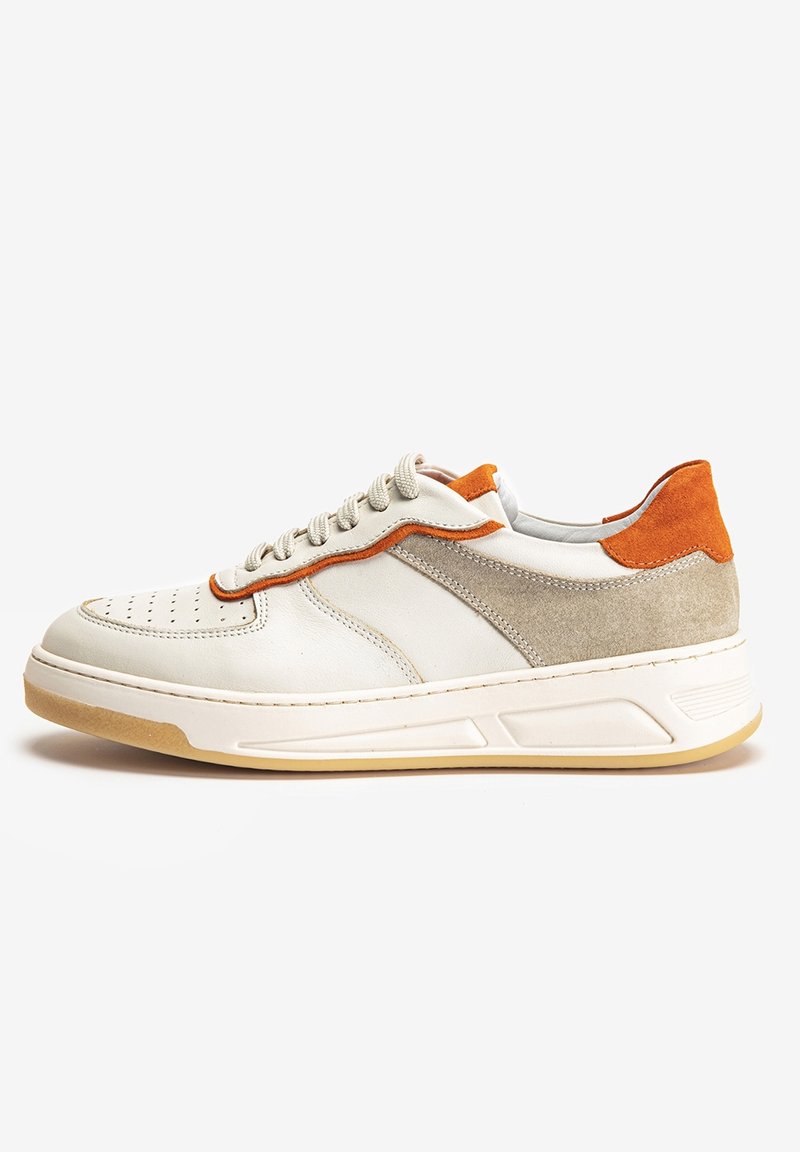 Men's sneaker featuring a cream leather upper, gray suede accents, orange heel, perforated toe, and a cream and gum rubber sole.