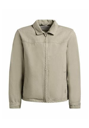 Bézs színű zipzáras dzseki gallérral, hosszú ujjakkal és oldalzsebekkel, fehér háttér előtt bemutatva.