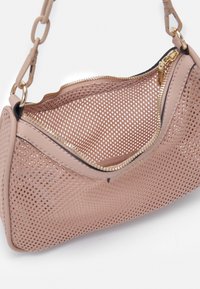Nätväska i ljusrosa med en strukturerad form, med en guldblixtlås, läderdetaljer och en kedjerem för enkel bärning.
