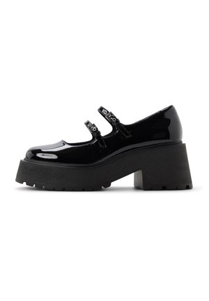 Black patent leather Mary Jane shoe with double buckle straps, thick lug sole, and chunky block heel, side view on white background.