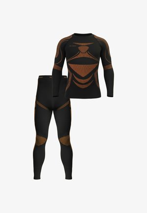 Black thermal activewear set featuring long-sleeve top and leggings with textured orange accents and ergonomic designs for improved fit.