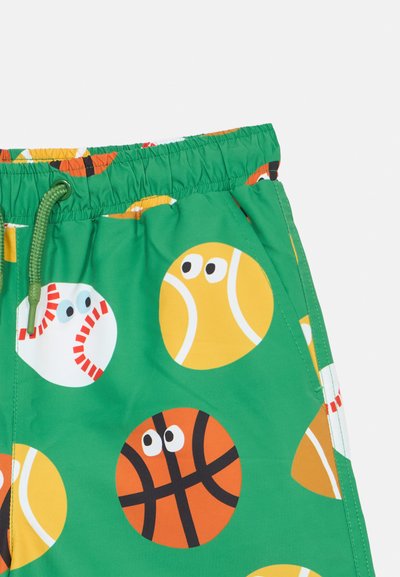 Πράσινο ύφασμα με αθλητικές μπάλες σε καρτούν στιλ που διαθέτουν μάτια, μεταξύ των οποίων μπέιζμπολ, μπάλες του τένις και μπάσκετ, κοντά στη ζώνη με κορδόνι.
