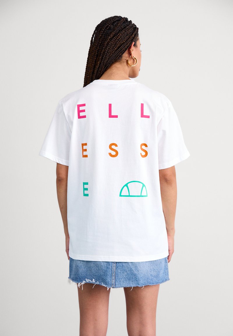 White cotton t-shirt with the word "WELLNESS" in pink, orange, and green letters; features a green half-circle graphic on the back.
