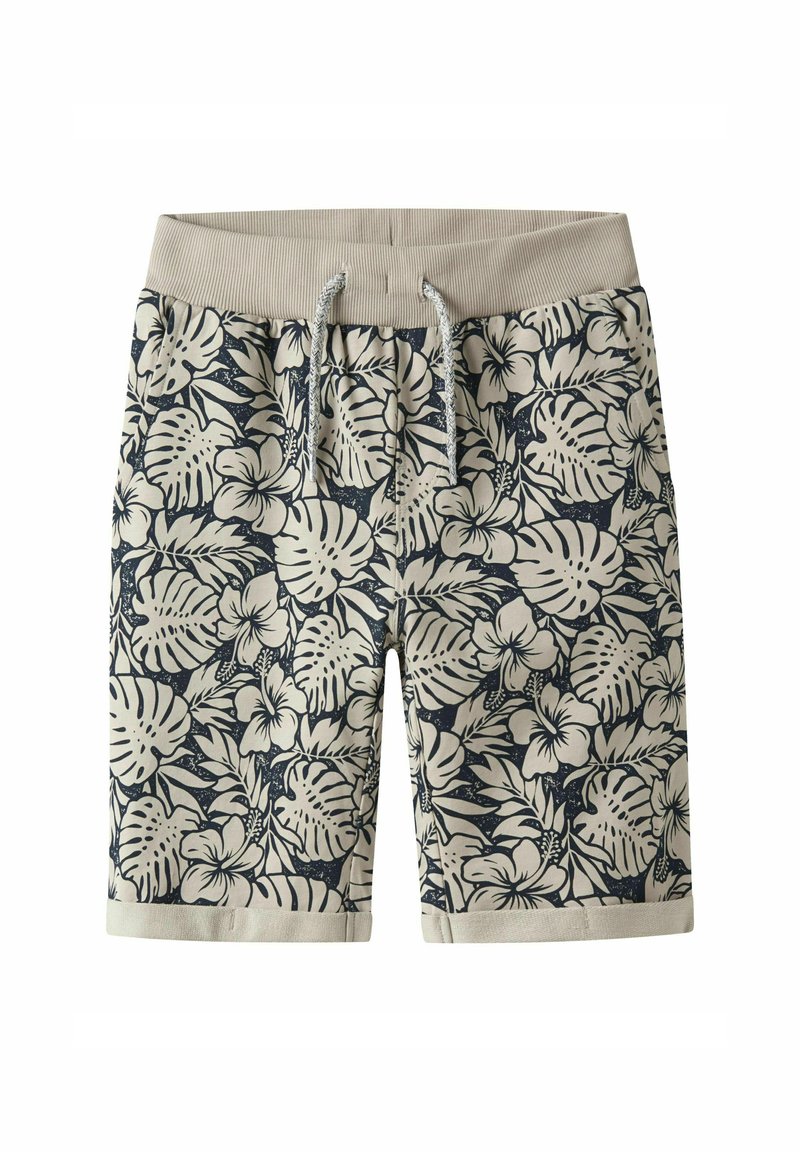 Shorts de bain floraux avec une taille élastique beige, présentant un motif tropical bleu marine de feuilles et de fleurs, fabriqués en tissu léger.