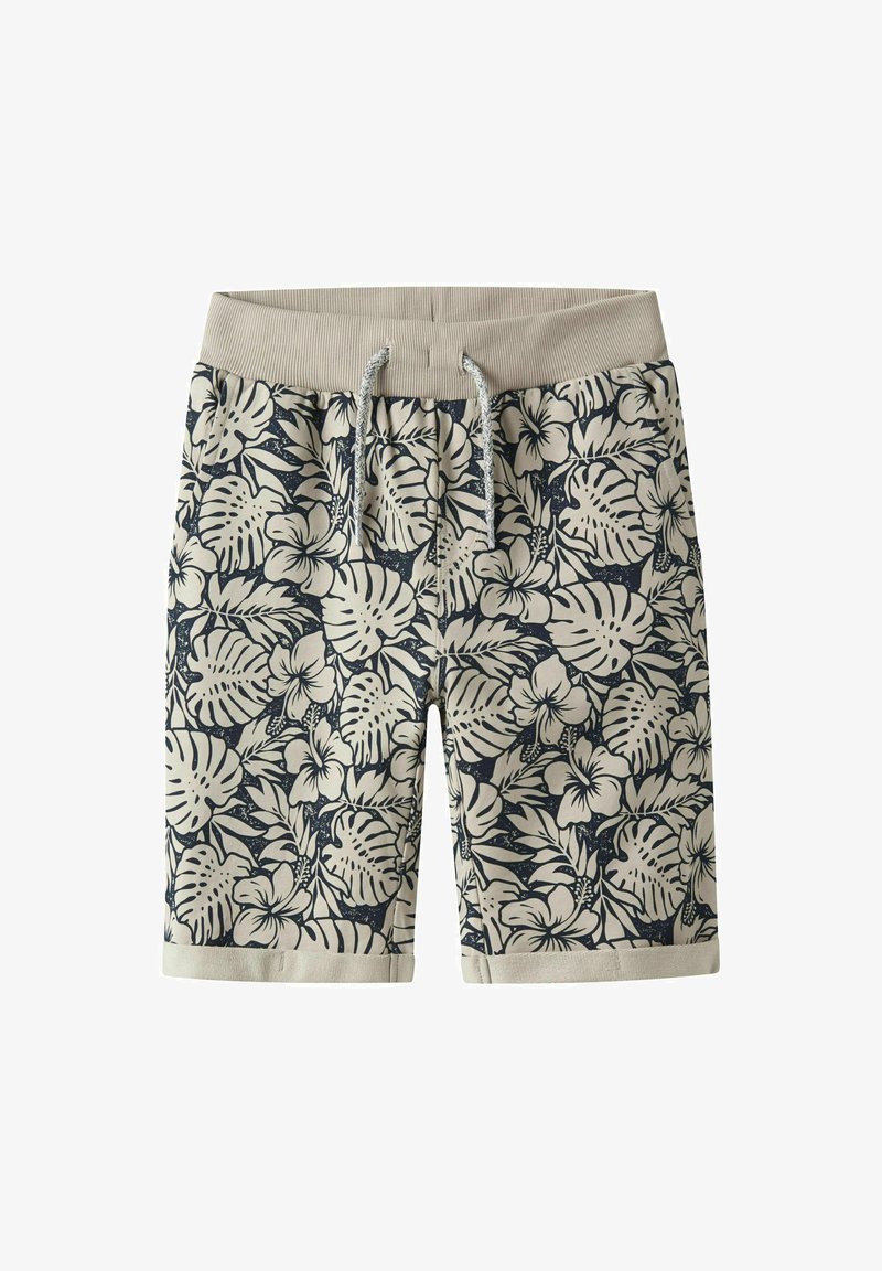 Kvetinové plavky s béžovým elastickým pásom, s námornícko modrým tropickým vzorom listov a kvetov, vyrobené z ľahkej textílie.