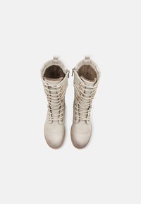 Lace-up boots in light beige leather with a smooth texture, featuring a soft inner lining, rounded toe, and a zip closure on the side.