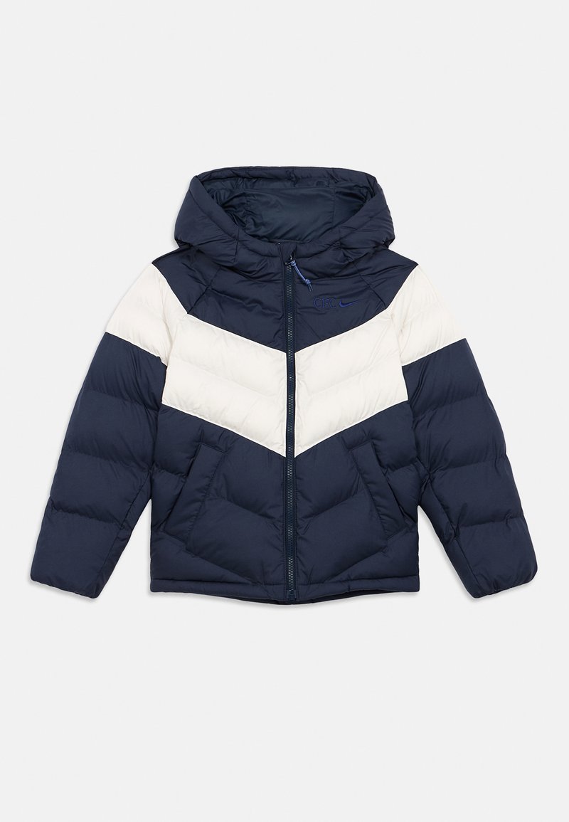 Navy blue puffer jacket with white chevron stripes, hood, and zip closure. Features two front pockets and stitched puffed texture.