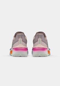 Sportschuhe mit einem hellgrauen Obermaterial, pinken und blauen Akzenten, gerundetem Absatz, grünem Logo und mehrfarbiger Sohle. Ausgestattet mit strukturierten Materialien.