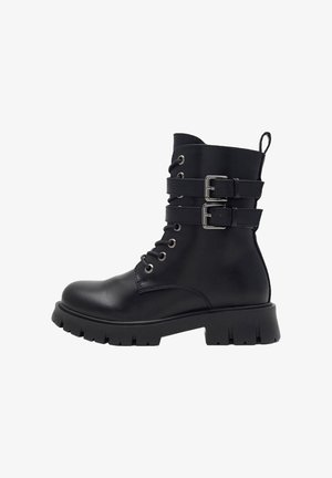 Black leather combat boot with thick tread sole, lace-up front, two adjustable buckle straps, and a pull tab at the back.