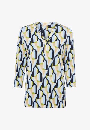 Blouse à manches longues avec motif géométrique en bleu clair, beige, vert olive et noir, présentant une encolure fendue et une coupe décontractée.