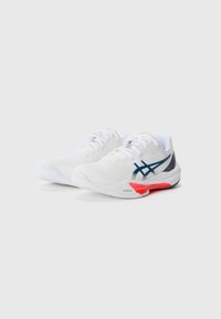 White athletic shoes with a textured upper, featuring blue and red accents. Profile includes a prominent logo and a durable rubber sole.