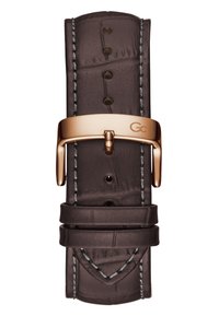 Brūns ādas pulksteņa siksna ar krokodila rakstu, pelēka šuvuma un zelta tonī metāla sprādze ar GC logotipu.