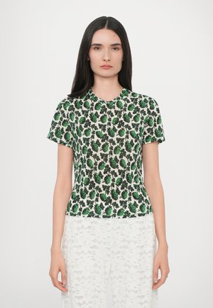 Short-sleeved top featuring a green and black floral pattern on a light background. Made of a lightweight fabric with a round neckline.
