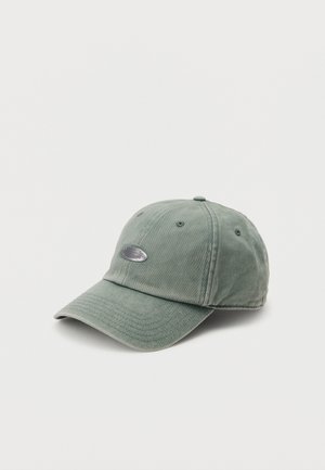 Light olive green baseball cap with curved brim and small oval silver logo plaque on front, displayed against a plain white background.