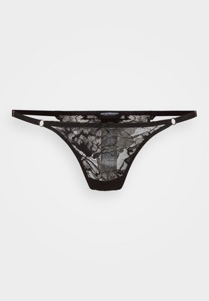 Zwarte kant thong met bloemenpatroon, voorzien van dunne banden en accenten in goudkleurige hardware. Het doorschijnende materiaal biedt een delicate textuur.