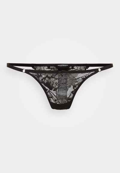 Black lace thong with floral pattern, featuring thin straps and gold-tone hardware accents. Sheer material offers a delicate texture.