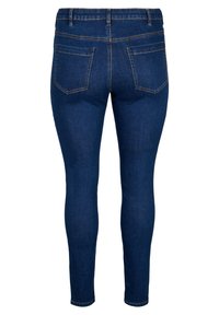 Jeans skinny in un blu scuro con una texture liscia, dotati di due tasche posteriori e dettagli di cucitura discreti.