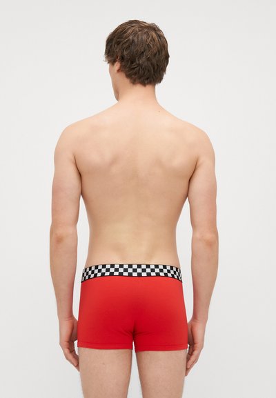 Red boxer shorts with a black and white checkered elastic waistband. The fabric appears smooth without visible patterns or designs.