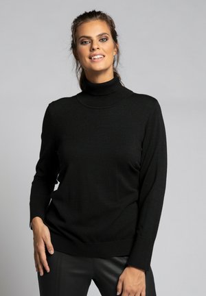 Pull encolure ras du cou noir avec des manches longues, des poignets côtelés et une coupe décontractée, fabriqué à partir d'un textile doux, présenté sur un fond gris.