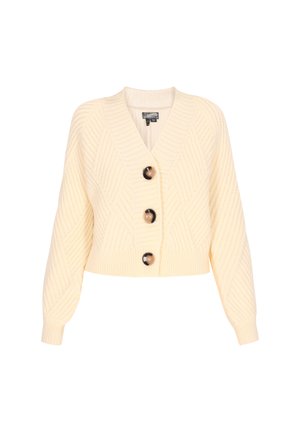 Pehmeast kreemivärvi kudum, millel on V-kaelus, pikad varrukad ja tekstuurne rombimuster; esiküljel on kolm suurt nuppu.