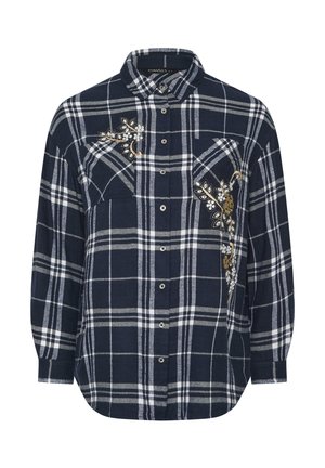 Mørkeblå ternet flannel skjorte med hvide linjer, prydet med blomsterbroderi på venstre bryst og to frontlommer. Knap-lukning design.