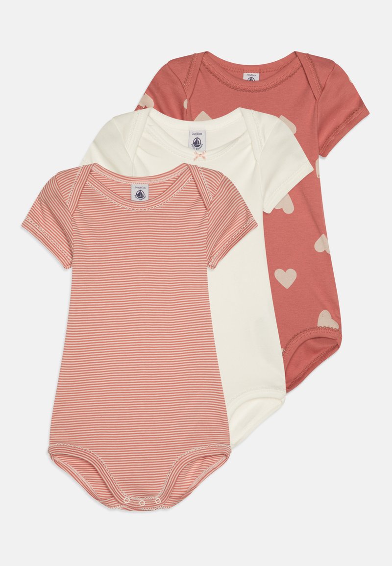 Three short-sleeve bodysuits in shades of coral and cream, featuring stripes, solid color, and heart patterns. Soft cotton fabric.