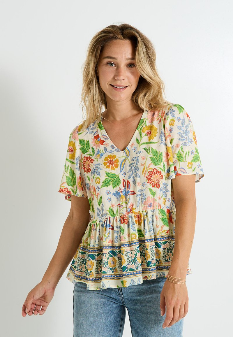 Top peplum floral en colores pastel con mangas cortas, escote en V y un dobladillo con volantes que presenta patrones decorativos en azul y verde.