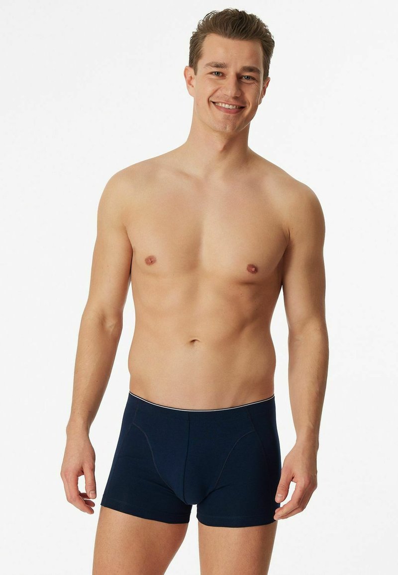 Navy blue cotton boxers with a snug fit, featuring a contrast waistband and subtle stitching details.