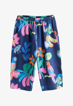Navy blue pants with bright tropical floral pattern including pink, orange, green leaves, parrots, and a frog, featuring an elastic waistband and side pockets.