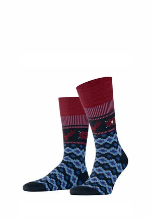 Red and navy patterned socks with a ribbed cuff, featuring reindeer and floral designs, made from a soft, textured fabric.