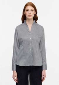 Long-sleeve button-up shirt in dark blue with a geometric pattern, featuring a mandarin collar and smooth fabric texture.