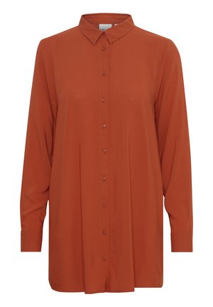 Chemise orange brûlé à manches longues avec col et poignets, coupe ample et boutons alignés au centre.