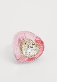 Heart-shaped pink plastic container with a clear crystal centerpiece surrounded by a gold-tone frame and small decorative stones.