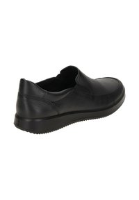 Black leather slip-on shoe with a textured surface, rounded toe, and a ridged rubber sole. Features minimal stitching and padded collar.