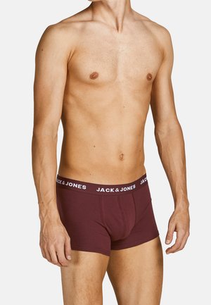 Burgunderfarbene Boxershorts mit einem weißen, gebrandeten Bund. Aus weichem Stoff gefertigt, bieten sie ein enganliegendes Design und Seitennähte für zusätzliche Struktur.