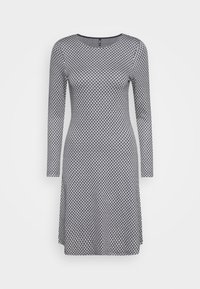 Pitkähihainen mekko musta-valkoisella geometrisella kuviolla, jossa on pyöreä pääntie, muotoonleikattu siluetti ja pehmeä joustava kangas mukavuutta varten.