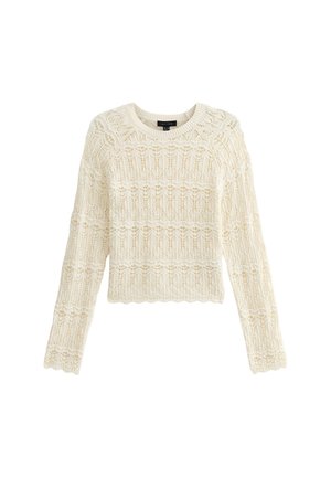 Pull crème à manches longues, présentant un motif en dentelle texturée et un ourlet en dents de scie. Encolure ronde et matériau en tricot léger et doux.