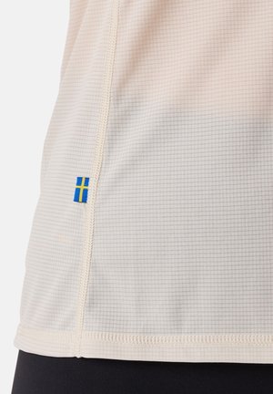 Light beige athletic shirt featuring a grid texture, bordered seams, and a small Swedish flag accent near the hem.